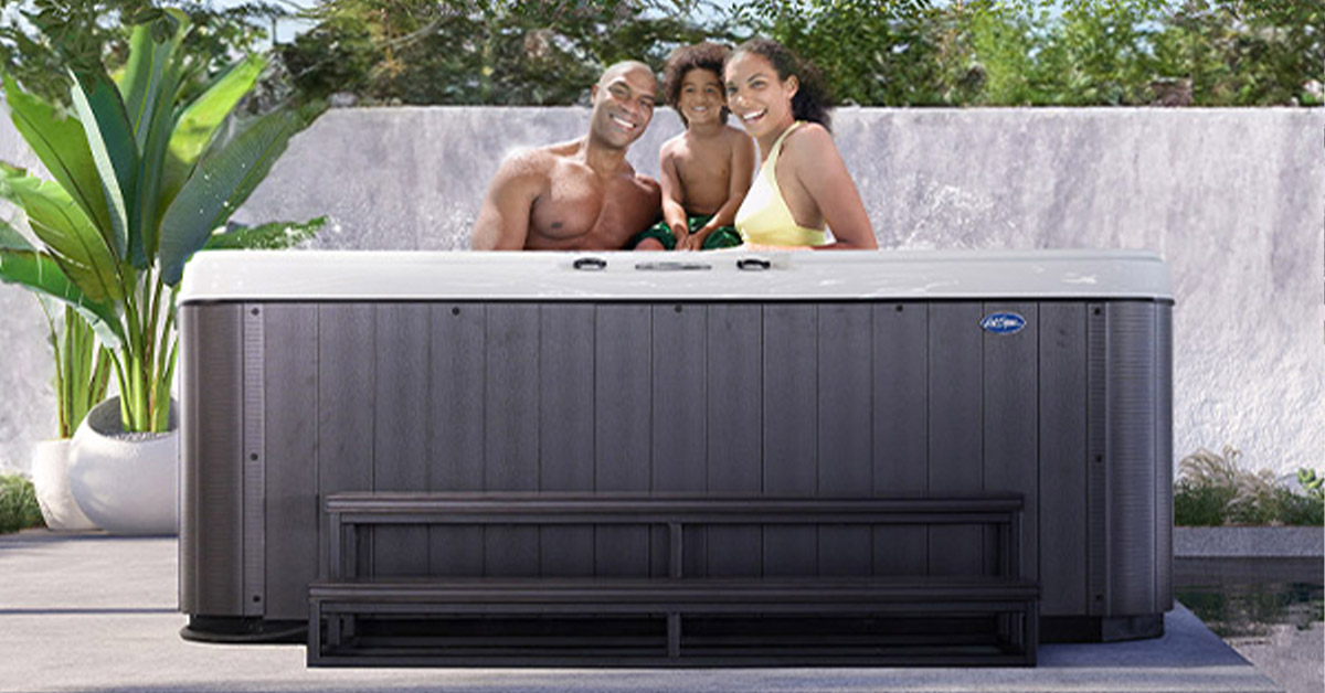 Parents and child in a Cal Spas Patio Plus hot tub, with 60-inch Cal Metro™ step